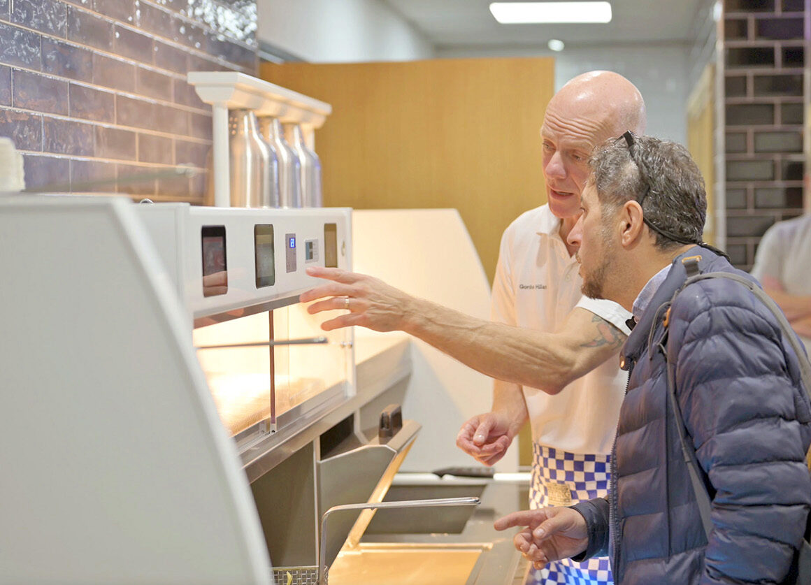 Gordon Hillan showing customer a Kiremko frying range