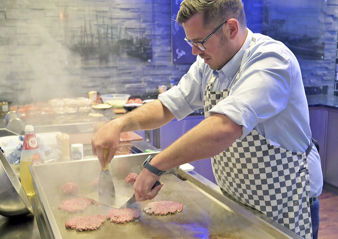 Richard Turner cooking smah burgers on an Adieu grill